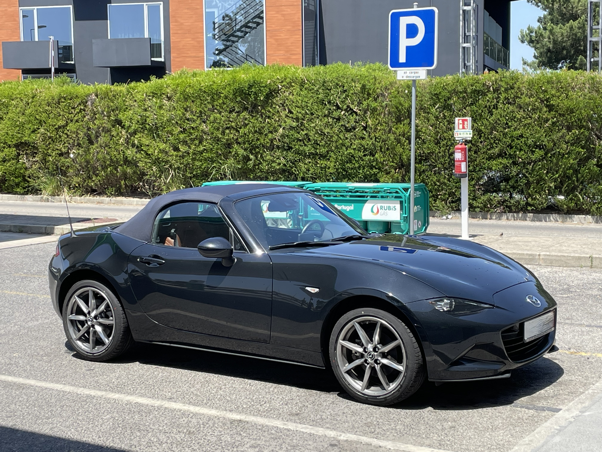 Original photograph of a Mazda MX-5 Miata with its dark roof closed
