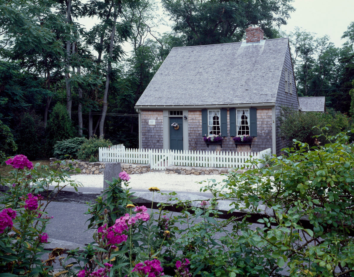 Original photograph of a Cape Cod cottage with blue shutters and a white picket fence