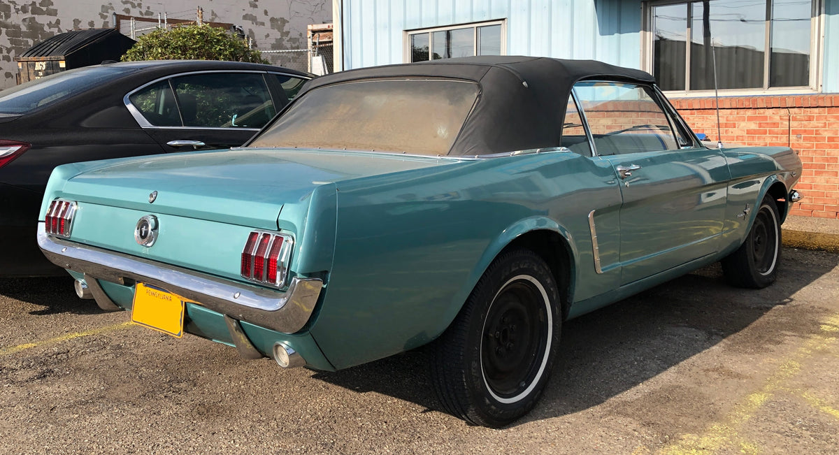Original photograph of a green classic Mustang convertible with its black roof closed