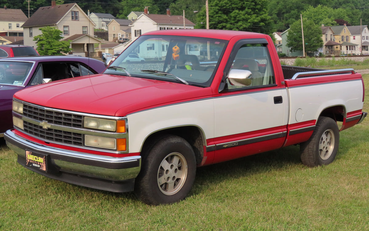Original photograph of a red and white Chevrolet C1500 Silverado pickup viewed from the front left